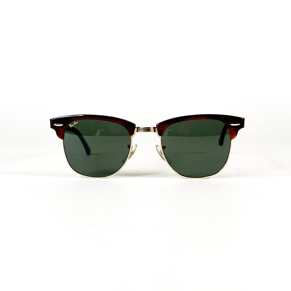 Vue de face d’une paire de lunettes Ray-Ban Clubmaster USA à monture écaillée et verres verts sur fond blanc