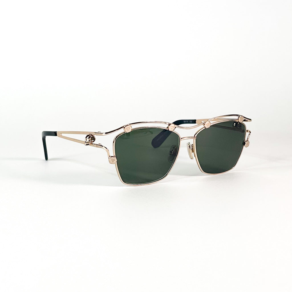 Lunettes Philipp Plein profil gauche – monture dorée avec verres verts et détails crâne