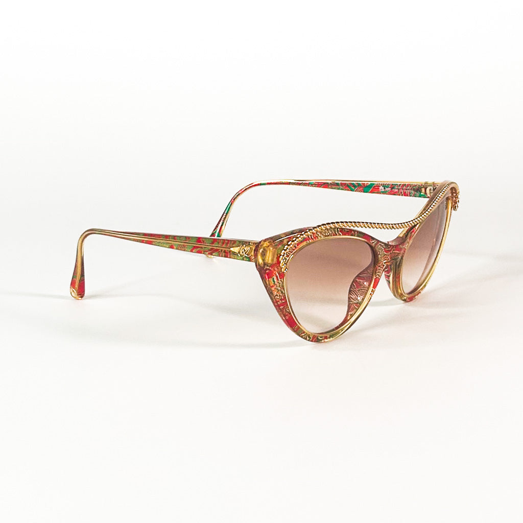 Lunettes Christian Lacroix pliées, chaînette dorée visible