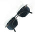 Vue de dessus des lunettes Carrera 5508 posées sur fond blanc, branches unies noires, verres semi-cerclés argentés et motif mosaïque orange-blanc-noir