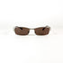 Vue de face d’une paire de lunettes Yves Saint Laurent 2080/S en métal brossé avec verres bruns sur fond blanc