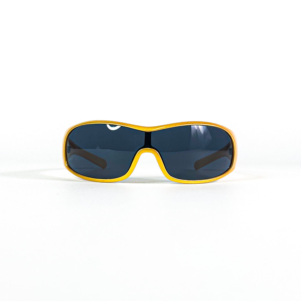 Lunettes Nouvelle Vague Rapid S109 posées à plat, vue en plongée sur la face dorée et les verres noirs