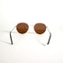 Détail de la branche fine en métal doré des lunettes vintage Morel avec plaquage or