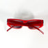 Vue de dessus des lunettes de soleil Gianfranco Ferré rouges, avec branches croisées