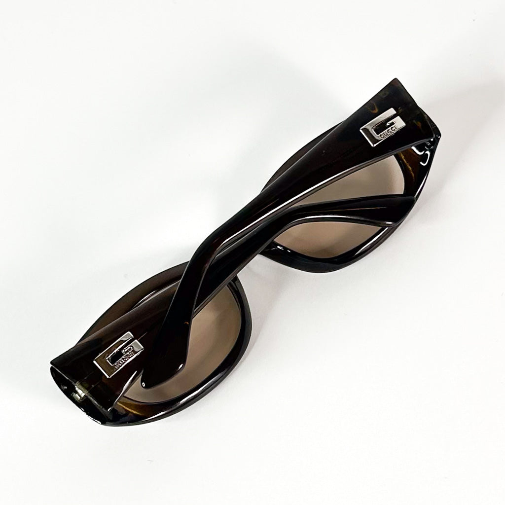 Lunettes de soleil Gucci vintage avec branches croisées en acétate marron translucide