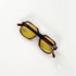 Lunettes Jean Lempereur 114 vue de dessus, branches repliées croisant le logo métallique JL