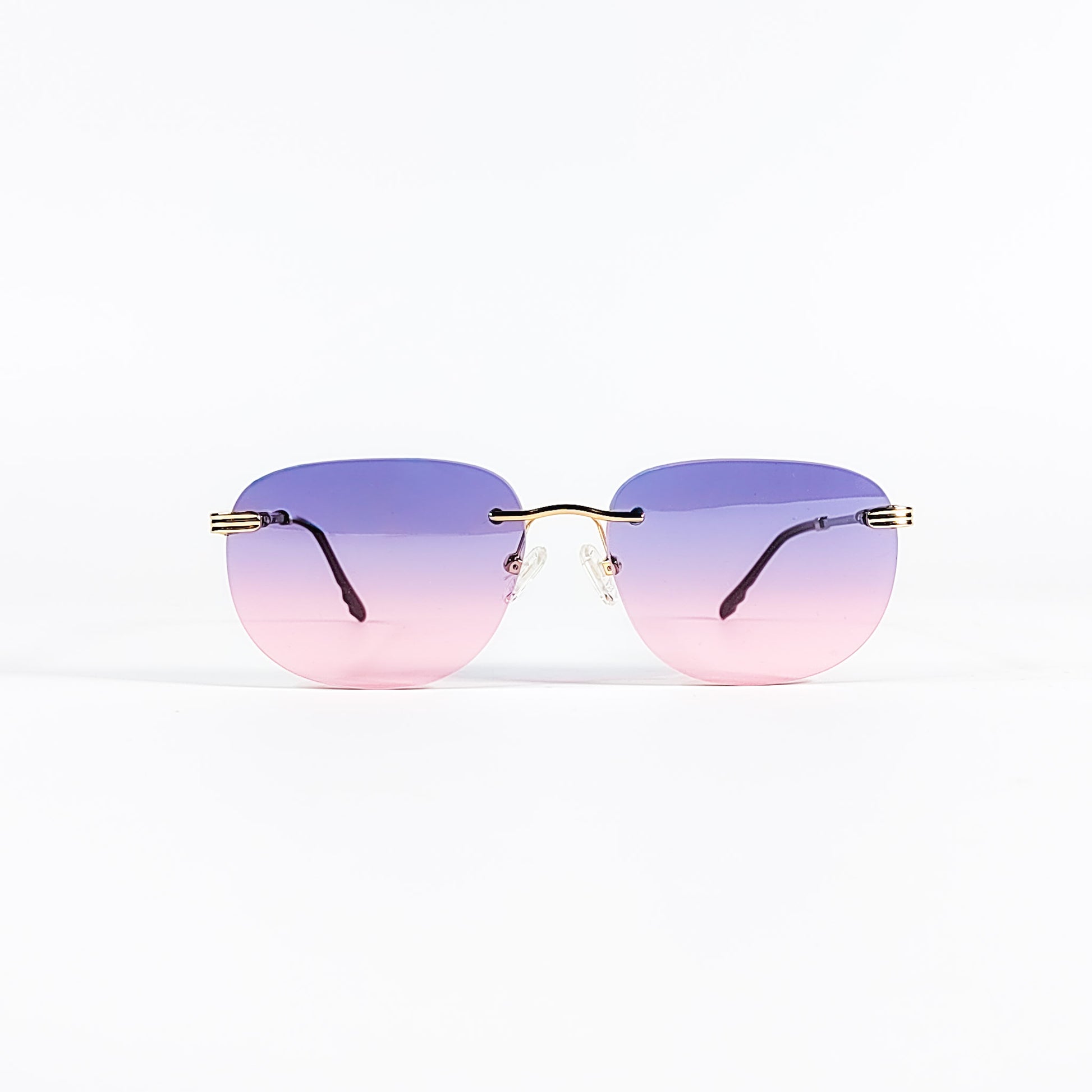 Lunettes de soleil vintage Porta Romana 1009 rimless métal doré, verres dégradés violet rose, vue de face centrée.